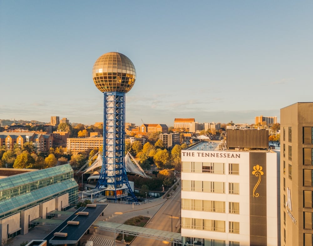 Knoxville Sunsphere: gold geodesic sphere atop a blue lattice tower over the downtown skyline.