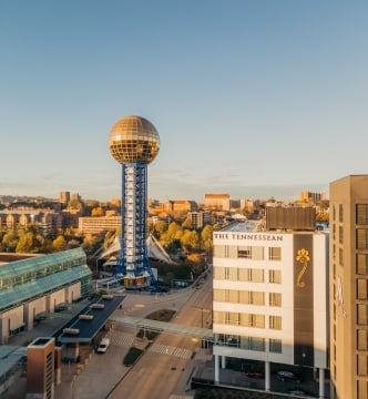 Knoxville Sunsphere: gold geodesic sphere atop a blue lattice tower over the downtown skyline.