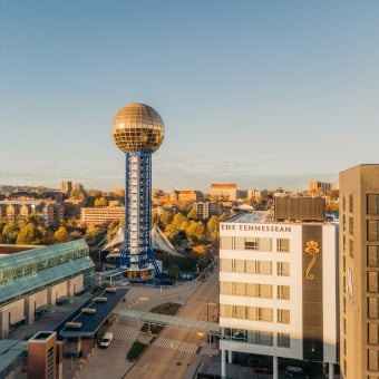 Knoxville Sunsphere: gold geodesic sphere atop a blue lattice tower over the downtown skyline.